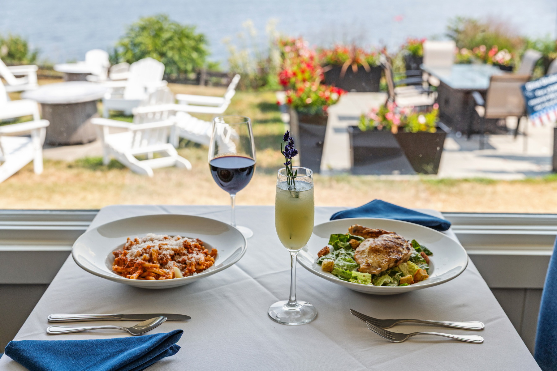 An example of entrees and a table with the lakeside view at Shore Acres Restaurant.