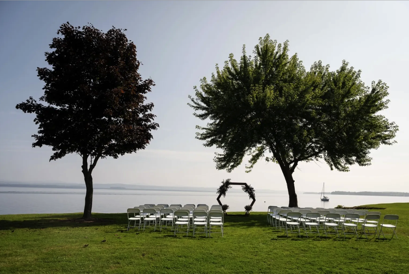 Chairs and an arch set up ready for a wedding on the shore of Lake Champlain at Shore Acres Inn and Restaurant in North Hero, Vermont.