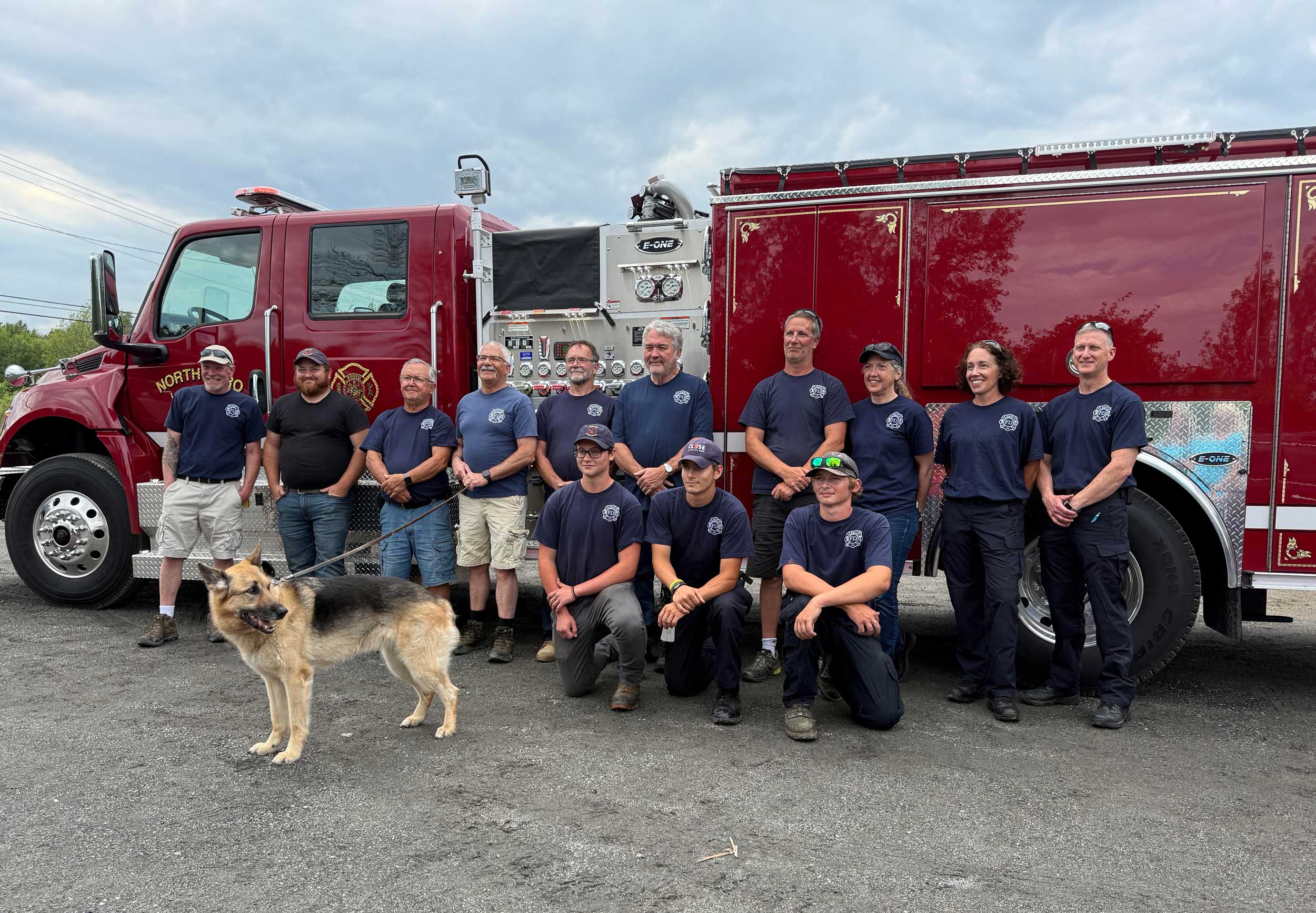 The North Hero Volunteer Fire Department stands in front of a firetruck.